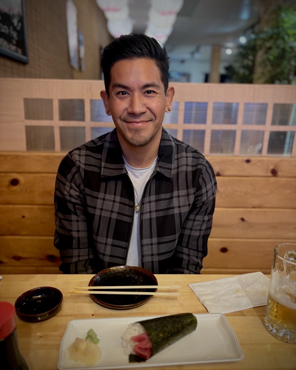 Edgar smiling at a restaurant table